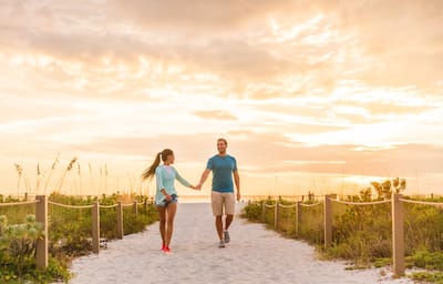 Young couple holding hands on Florida vacation holidays. 