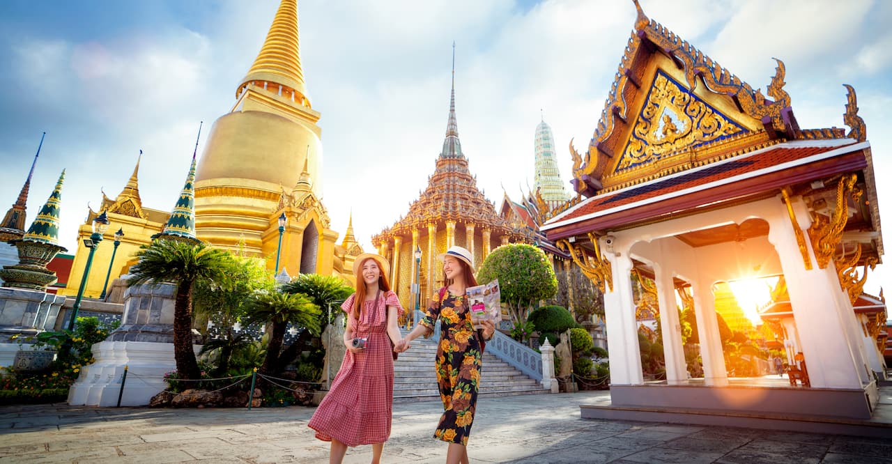 Asian girl walk in Wat phra kaew and grand palace travel in Bangkok city, Thailand