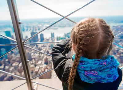 Little girl enjoy view to New York City from Empire State Building