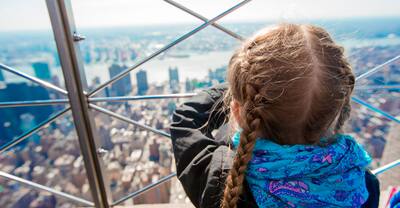 Little girl enjoy view to New York City from Empire State Building