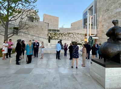 Group of people admiring sculptures and statues outdoors at the Getty Center. 
