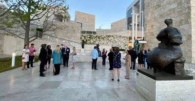 Group of people admiring sculptures and statues outdoors at the Getty Center. 
