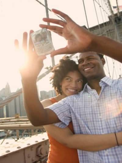 Couple taking a picture of themselves on the Brooklyn Bridge