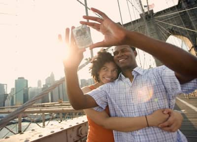Couple taking a picture of themselves on the Brooklyn Bridge