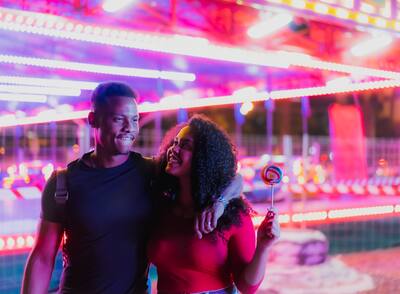 Young smiling couple after having a ride at a state fair.