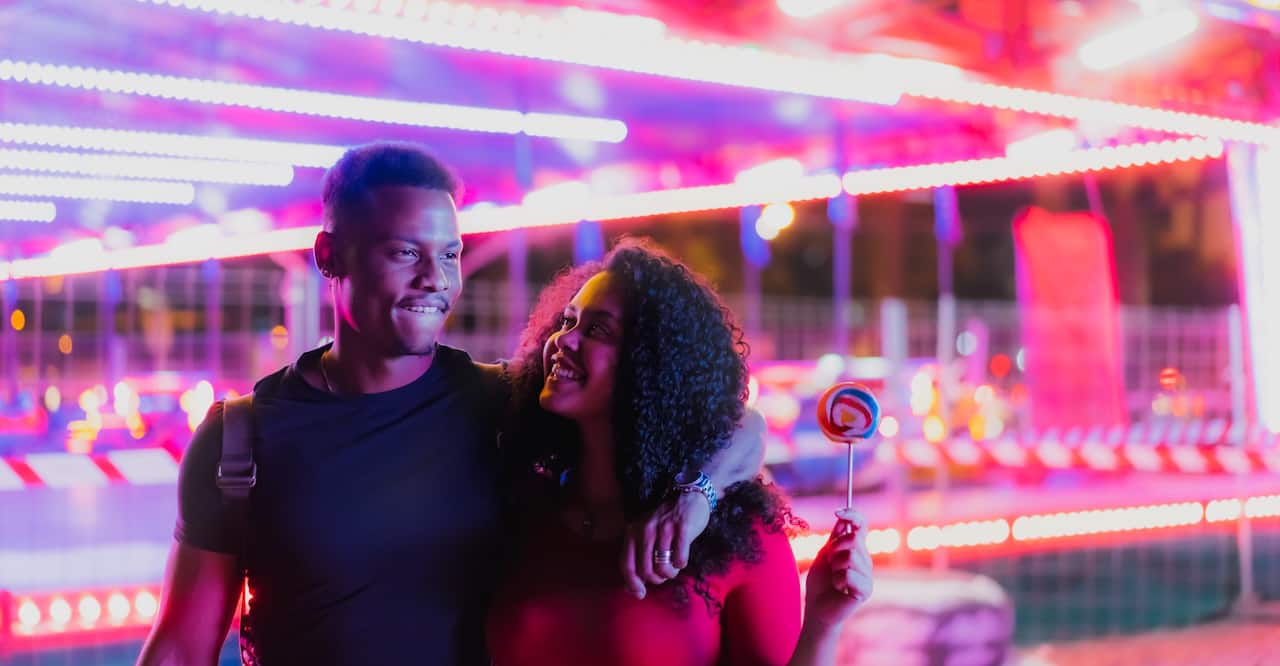Young smiling couple after having a ride at a state fair.