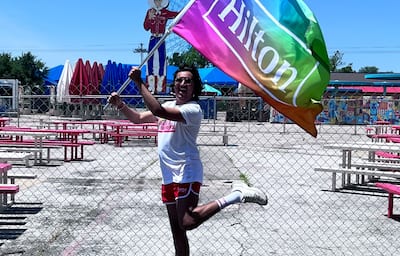 Man in red shorts with Hilton Pride flag at Dallas Pride 2022