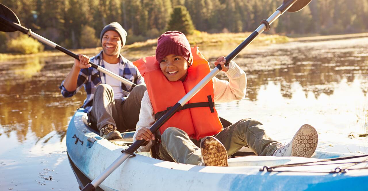 Man and boy sit on kayak