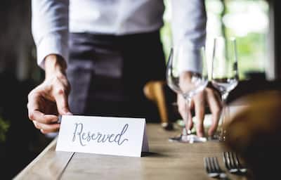 Server places 'Reserved' sign on table