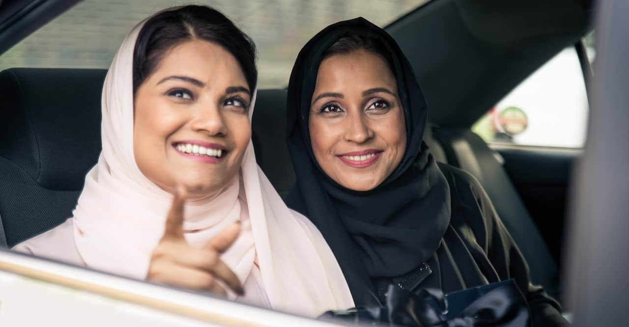 Two women in a taxi cab in Dubai. 