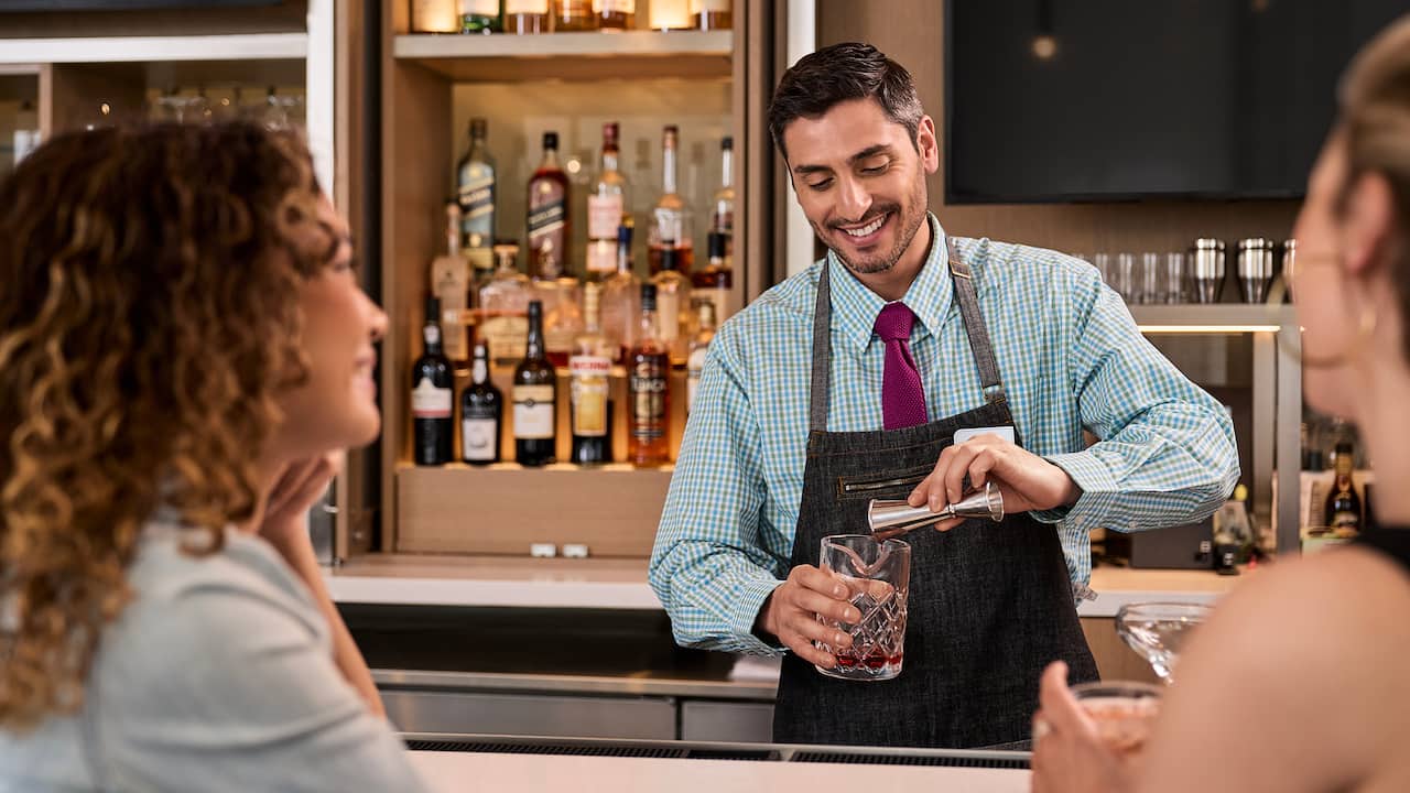 Two people having a beverage at the bar