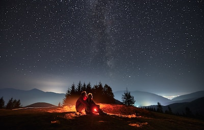 People stargazing in a park at night