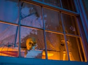 Spooky Halloween decorations in a window.
