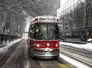 Toronto streetcar traveling down Queen Street in the winter.