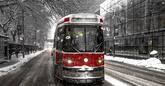 Toronto streetcar traveling down Queen Street in the winter.
