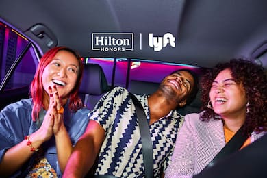 Group of three friends in Lyft together laughing