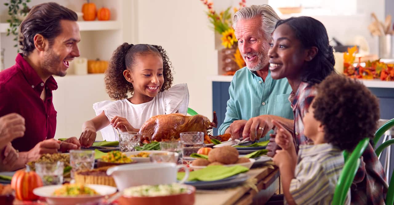 Multi-generation family celebrating Thanksgiving at home.