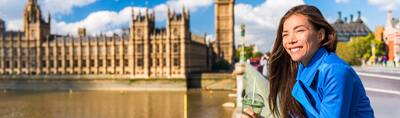 A female tourist drinking a green smoothie not far from Big Ben in London.