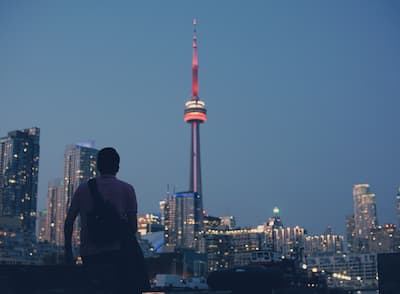 Person gazing at the CN Tower in Toronto, Canada. 