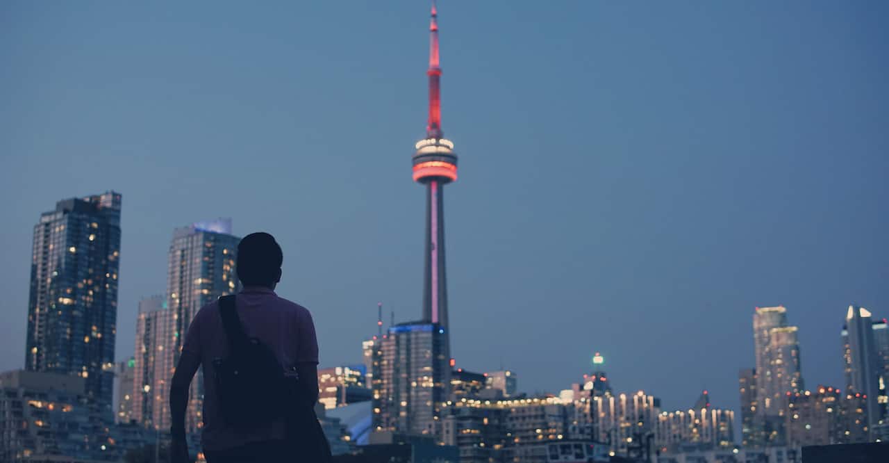 Person gazing at the CN Tower in Toronto, Canada. 