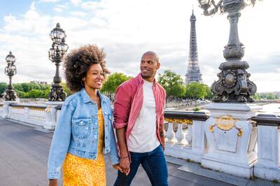 Black cheerful happy couple in love visiting Paris city centre and Eiffel Tower.
