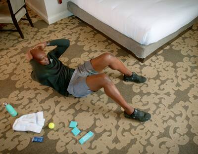 Man doing crunches in his hotel room