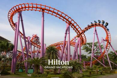 red and purple roller coaster with Hilton Grand Vacations logo overlay