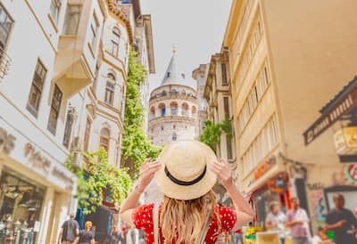 The backside of a woman looking at a view of Galata tower in Beyoglu,Istanbul,Turkey.