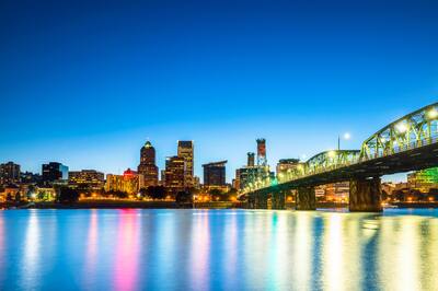 View of Portland skyline from the water at night time.