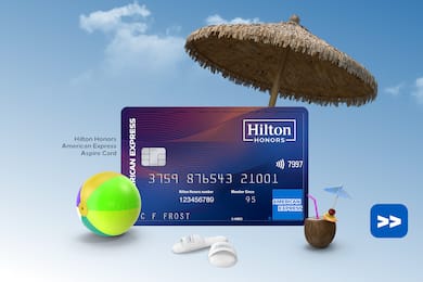 Hilton Honors American Express Aspire Card floating on a sky background