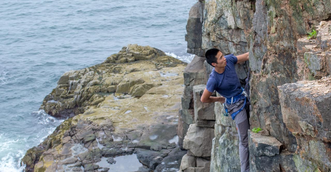 Man rock climbing in acadia park