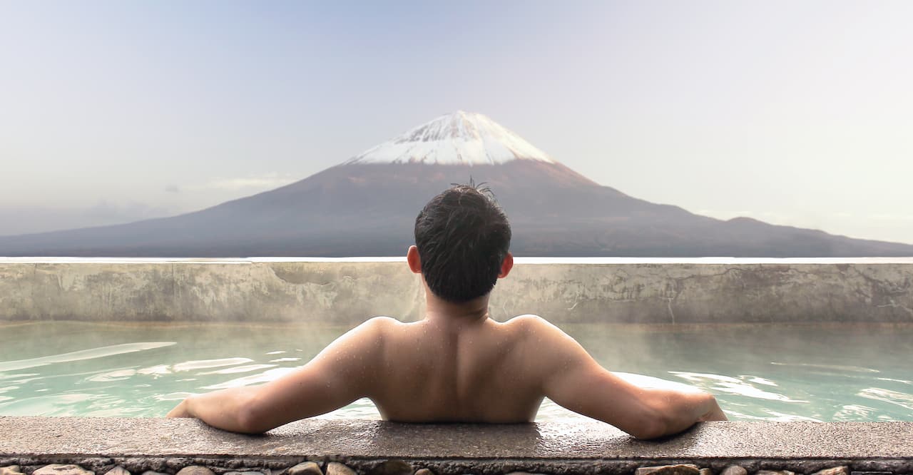 man relaxing in onsen bath 
