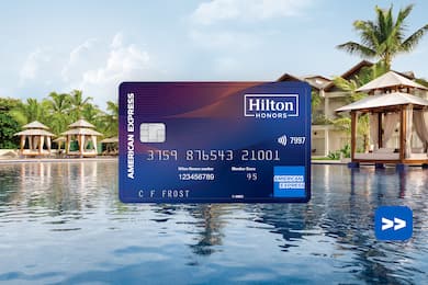 Hilton Honors American Express Aspire Card in front of a swimming pool background