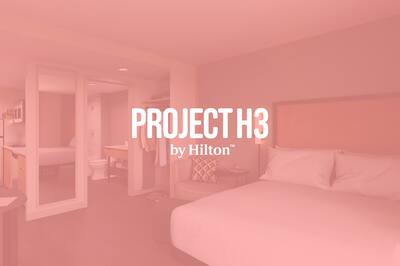 A guest room image with the Project H3 by Hilton logo layered over the top