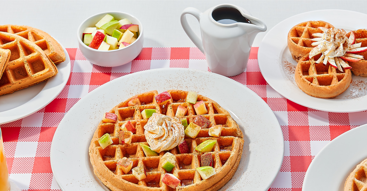 Apple cinnamon waffles on a table with drinks