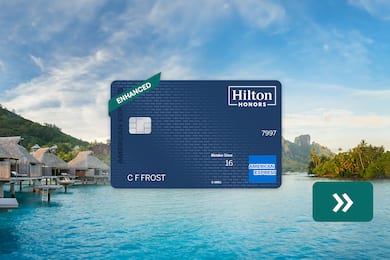 The Hilton Honors American Express Surpass® Card with a beach in the background