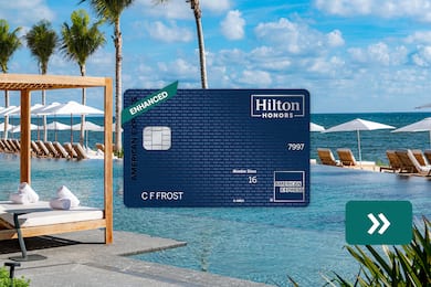  The Hilton Honors American Express Aspire Card with a resort hotel in the background