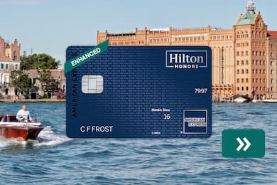 The Hilton Honors American Express Aspire Card with a boat in the background