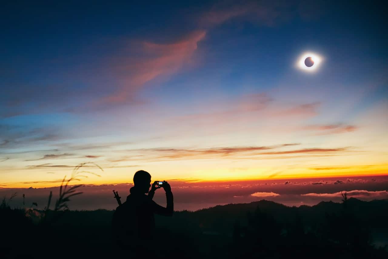 Solar eclipse on a colorful sky.
