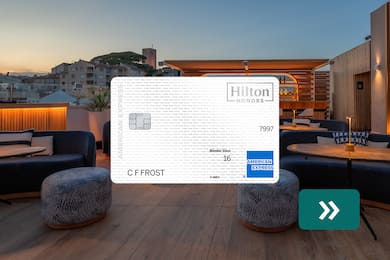  The Hilton Honors American Express Card with a rooftop bar in the background