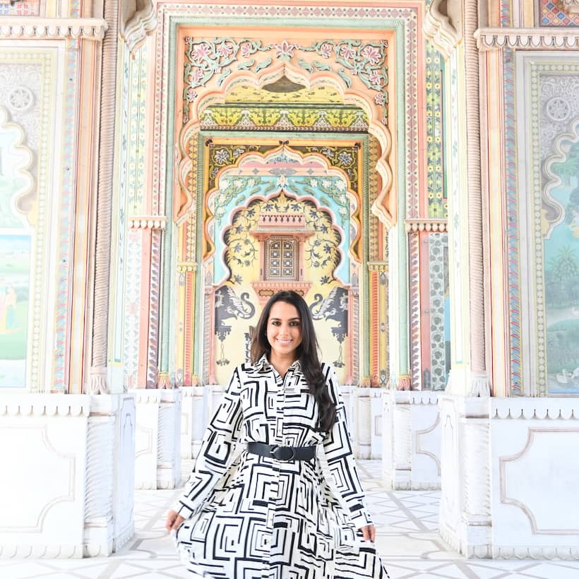 Influencer Monica Vaswani poses in ornate doorway in Jaipur