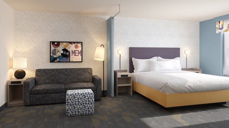 Example rendering of studio suite with one king bed and sofa