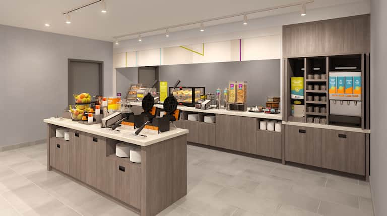 Example rendering of self-serve breakfast area with waffle irons, fruit, pastries and hot food