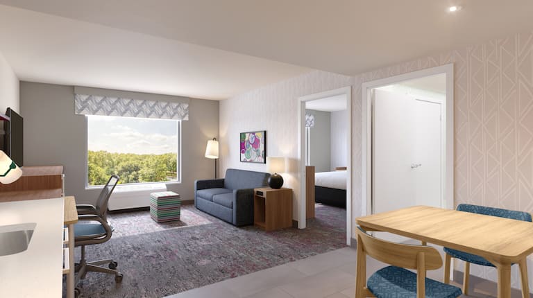 Example rendering of suite with separate bedroom and living area with sofa, desk, TV and dining table with two chairs