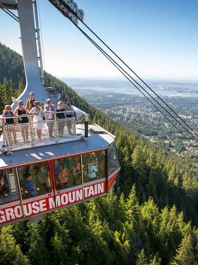 People stand on roof of Sky Ride gondola at Grouse Mountain, Vancouver