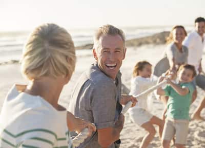 Family Playing Tug-of-War on the Beach
