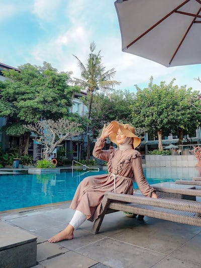 Woman sitting by pool