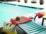 Outdoor Pool with Hat, Towel, Beach Bag, Drink, and Flip Flops