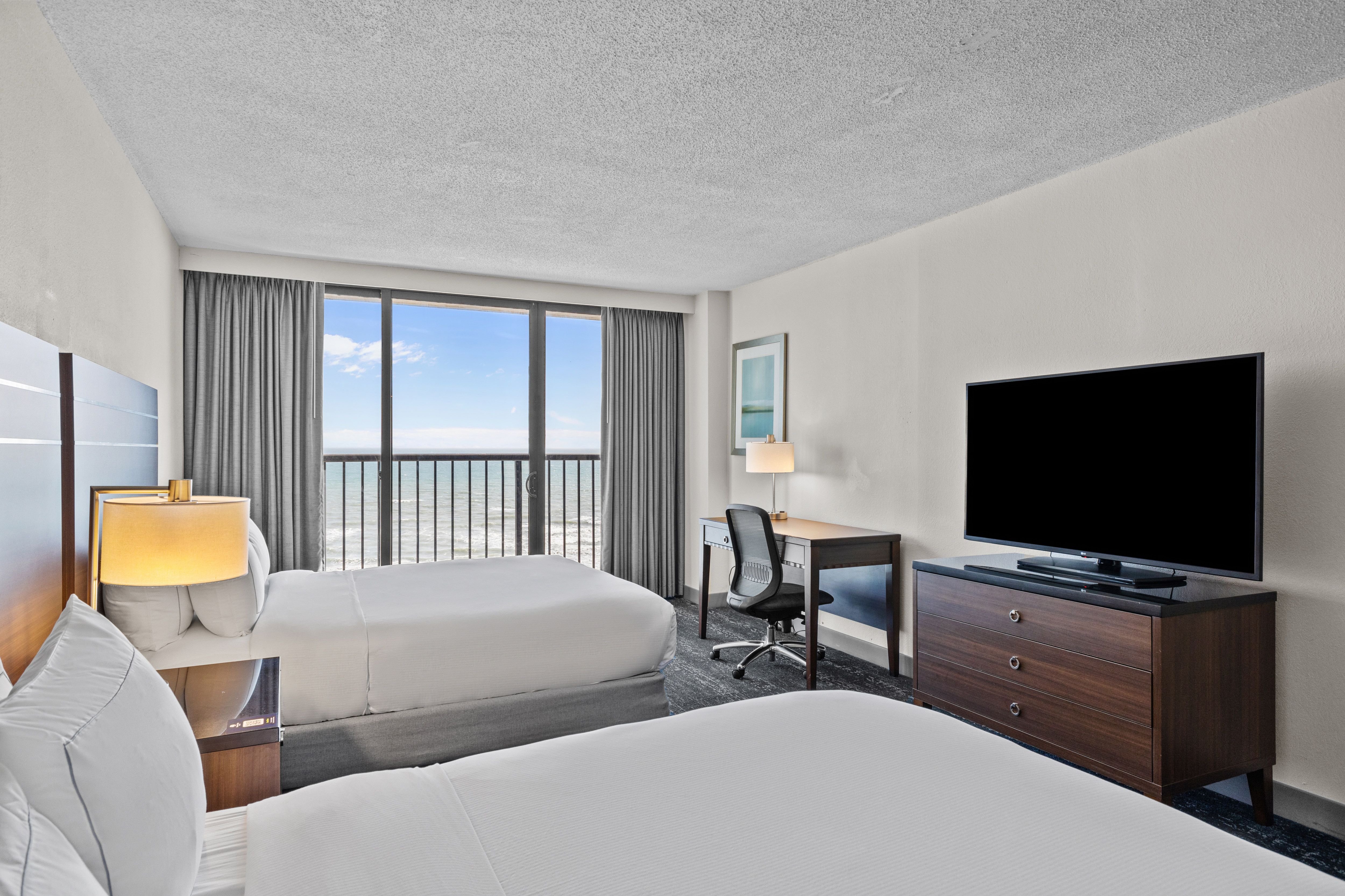 Two Beds Desk and HDTV in a Guest Room with Ocean View