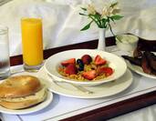 Close Up of Room Service Tray WIth Breakfast Items on Bed